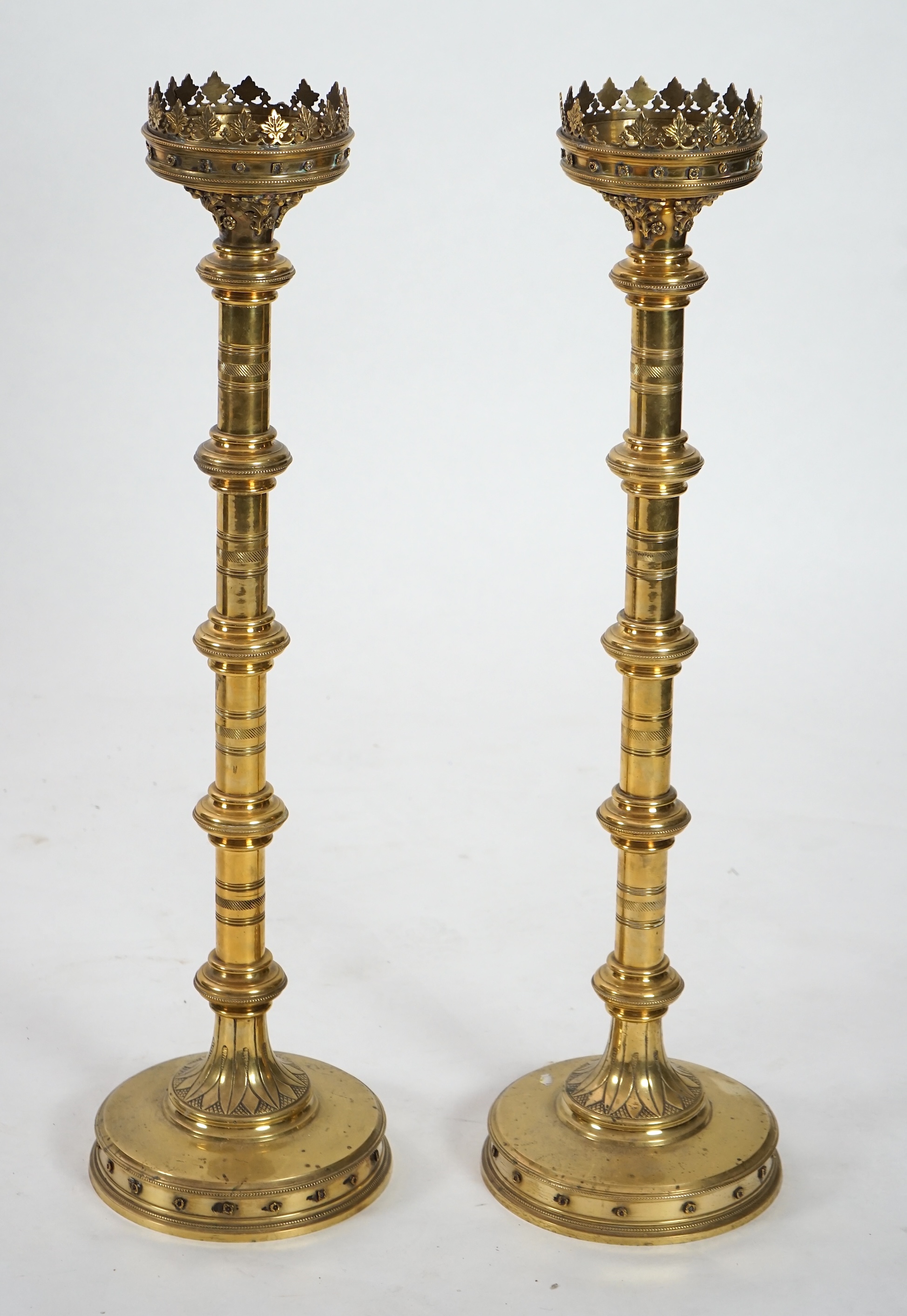 A pair of Victorian Gothic brass altar sticks